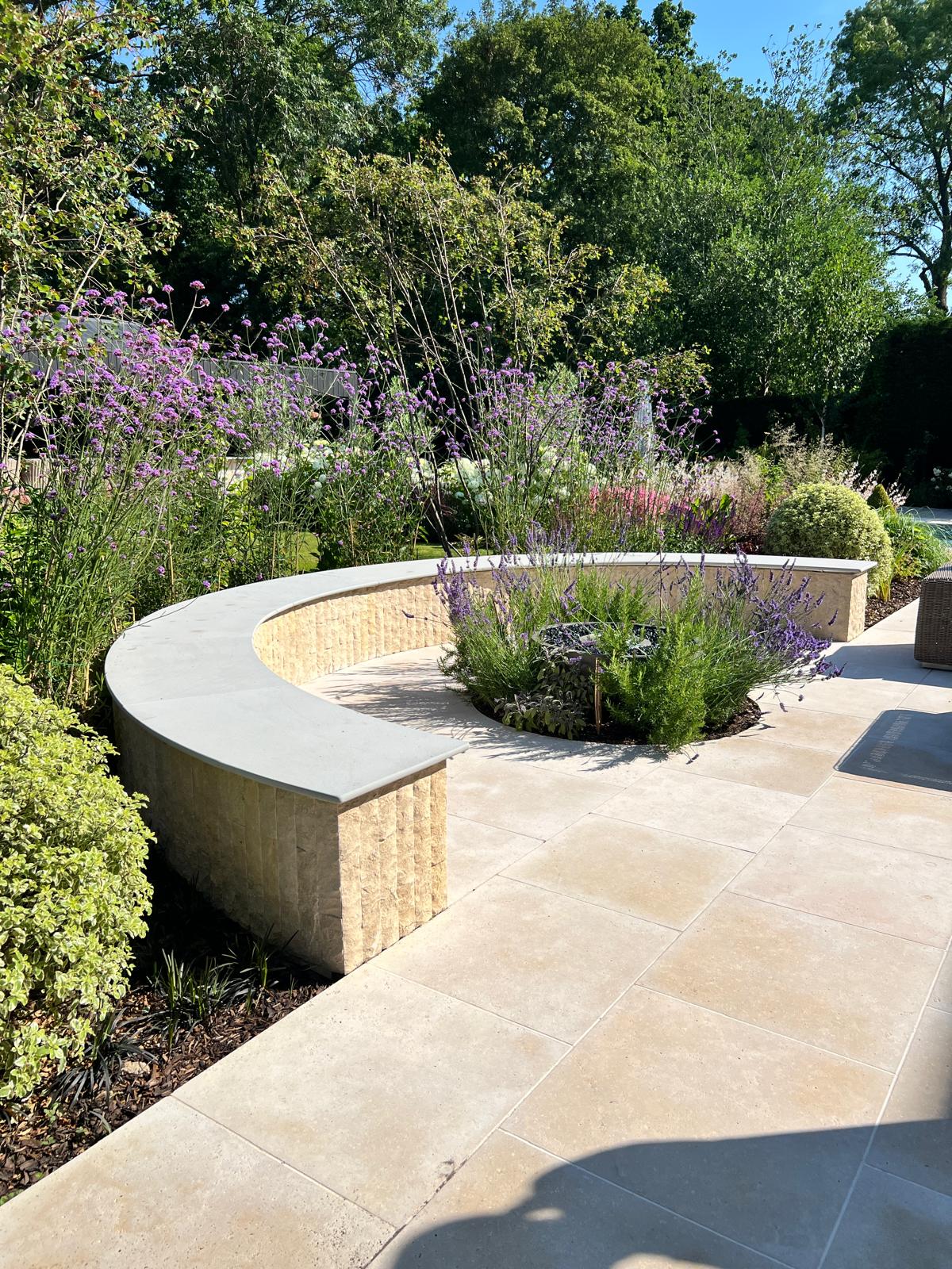 Curved seating wall and planting from the pool terrace