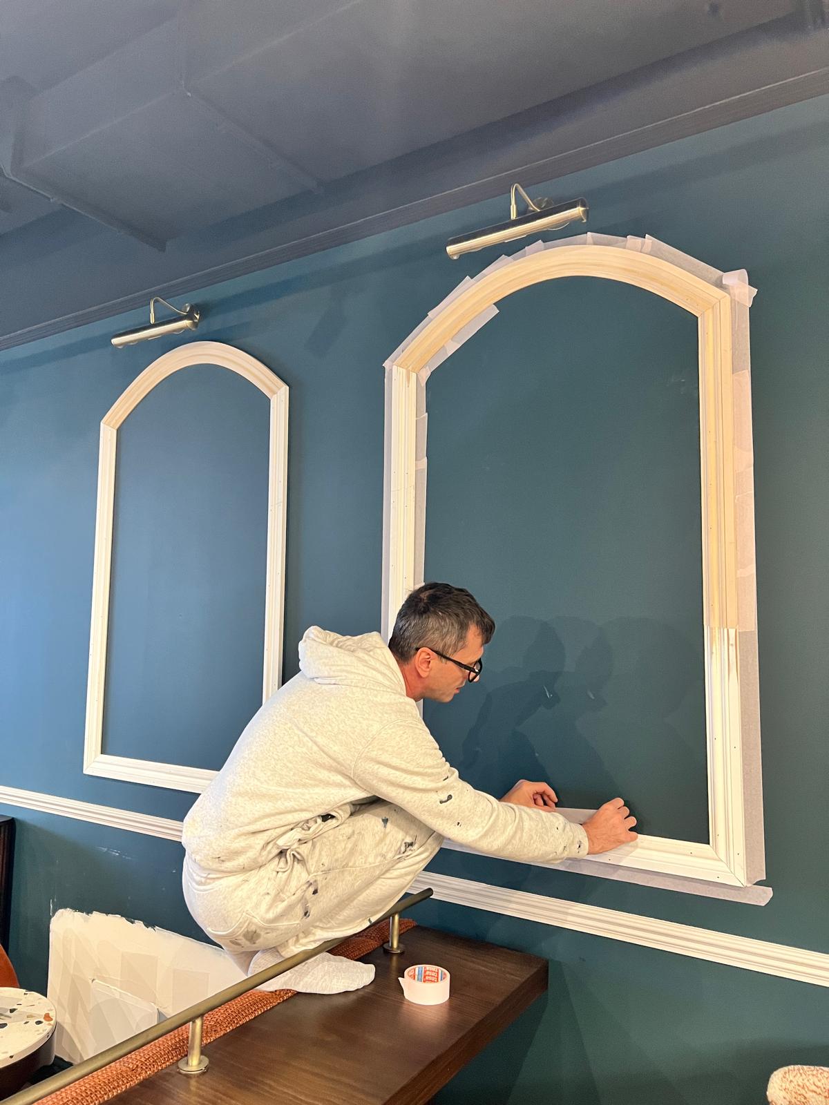 Decorator hand-finishing the panelled arches