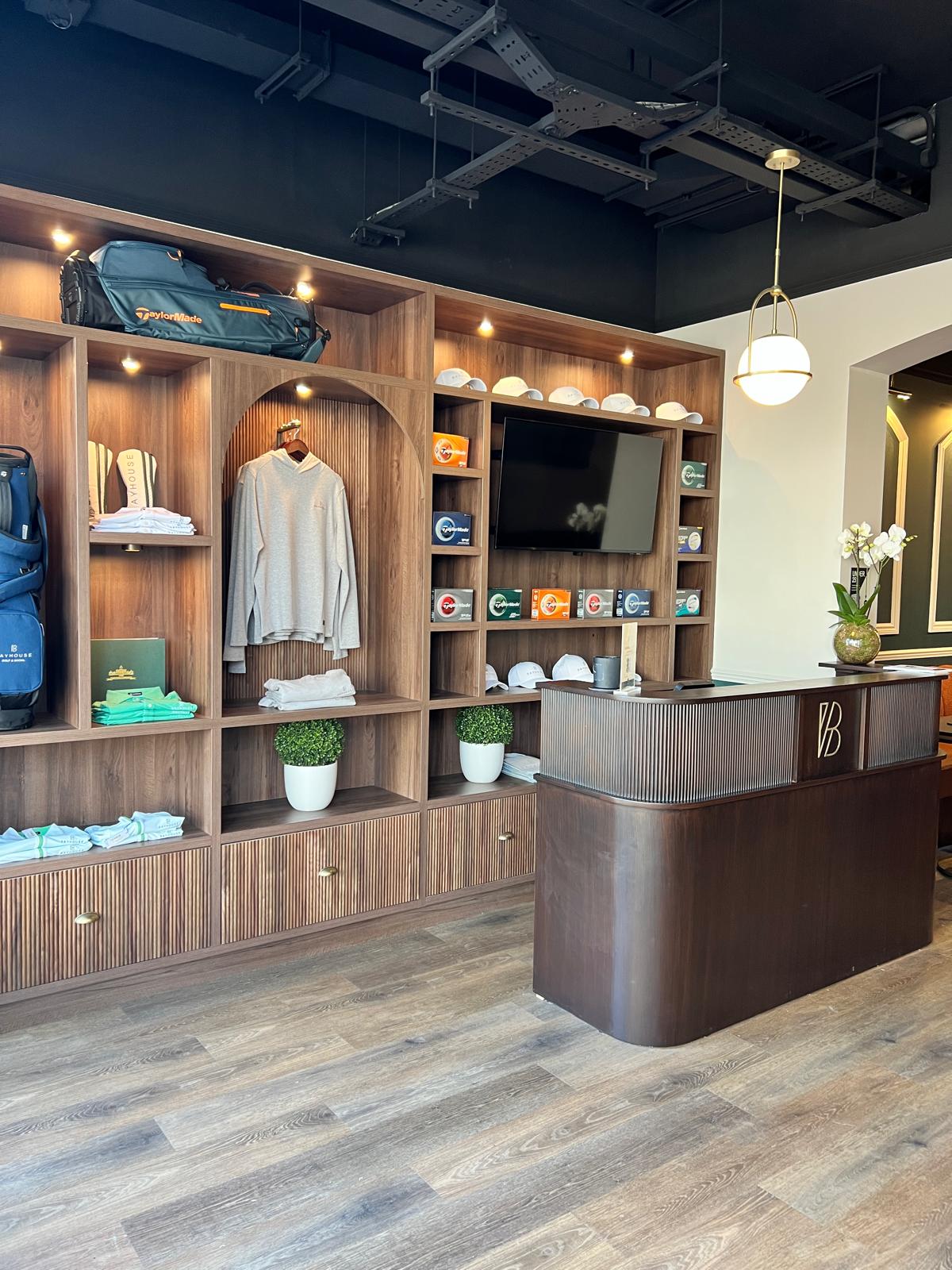 Walnut reception desk and retail display wall